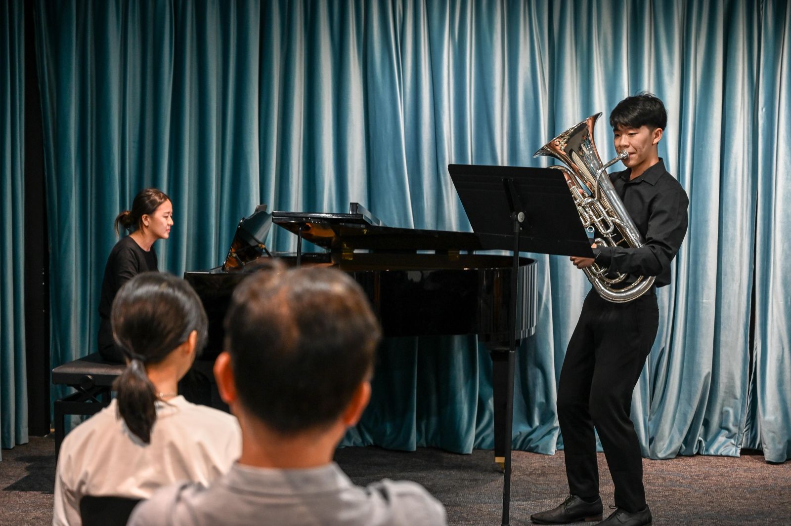 A student playing euphonium with a pianist