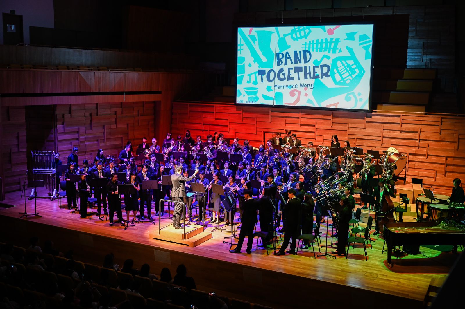 A wind band on stage in concert